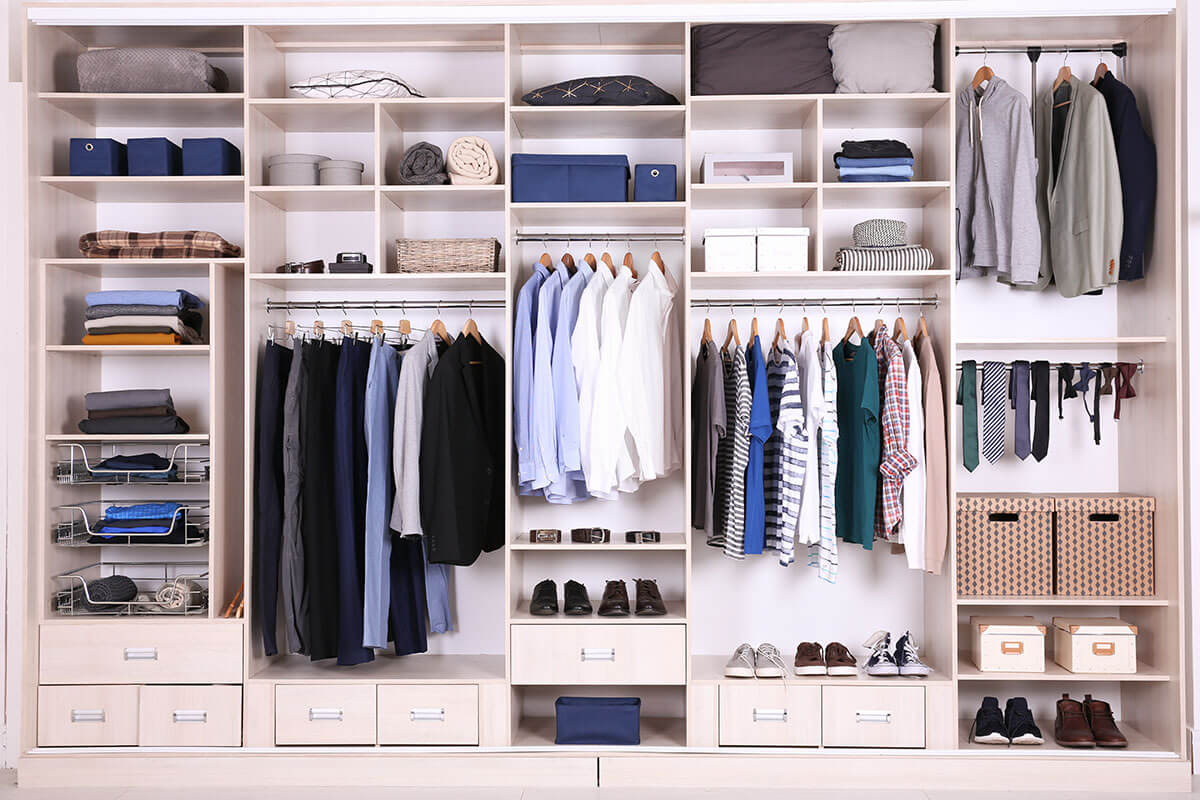 Large closet with clothes and shoes