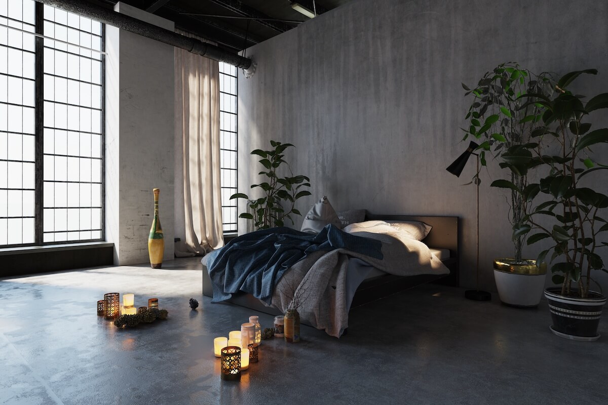 Gray themed bedroom with lit candles on the floor