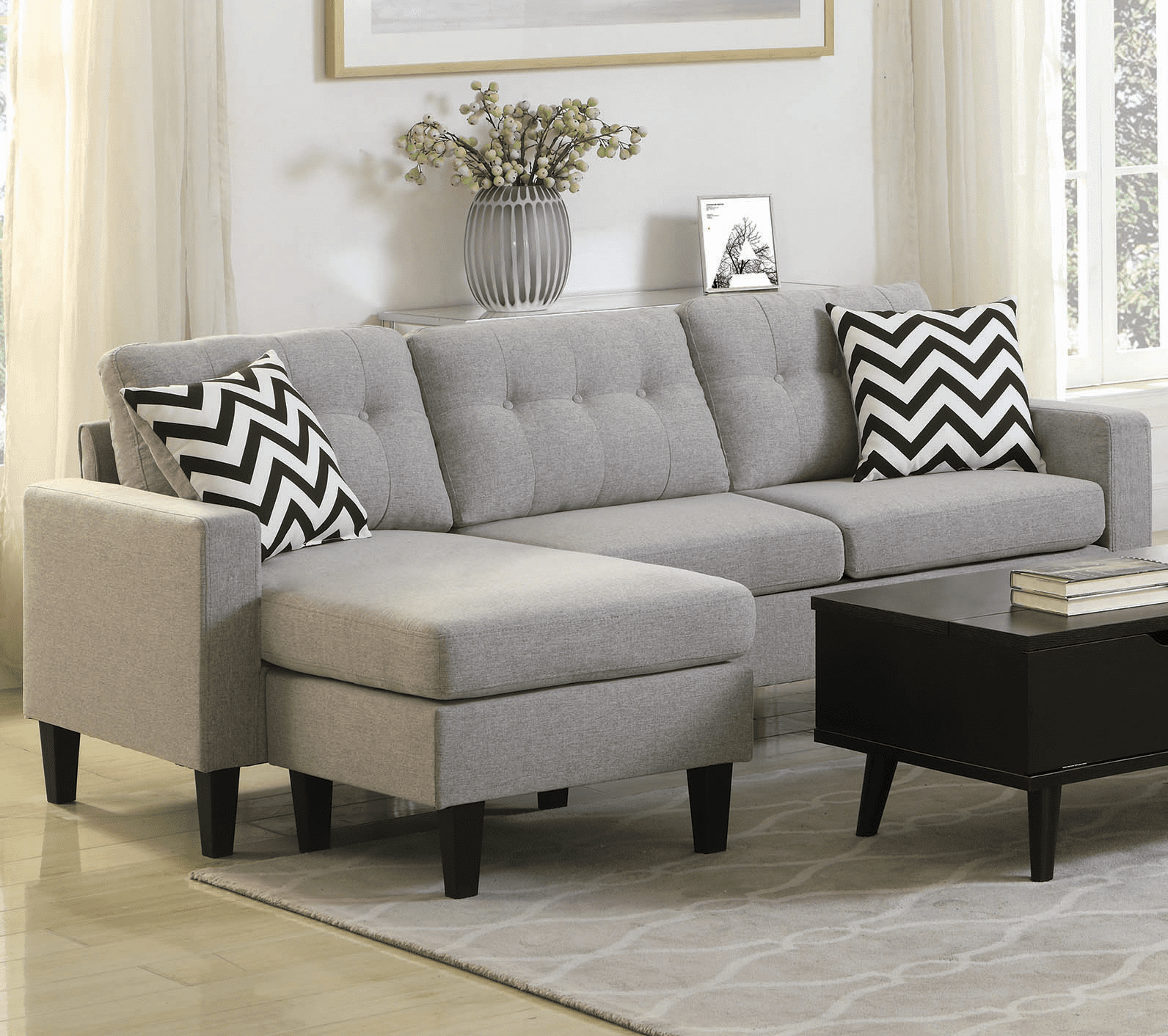 light gray small sectional sofa with black and white stripe pillows