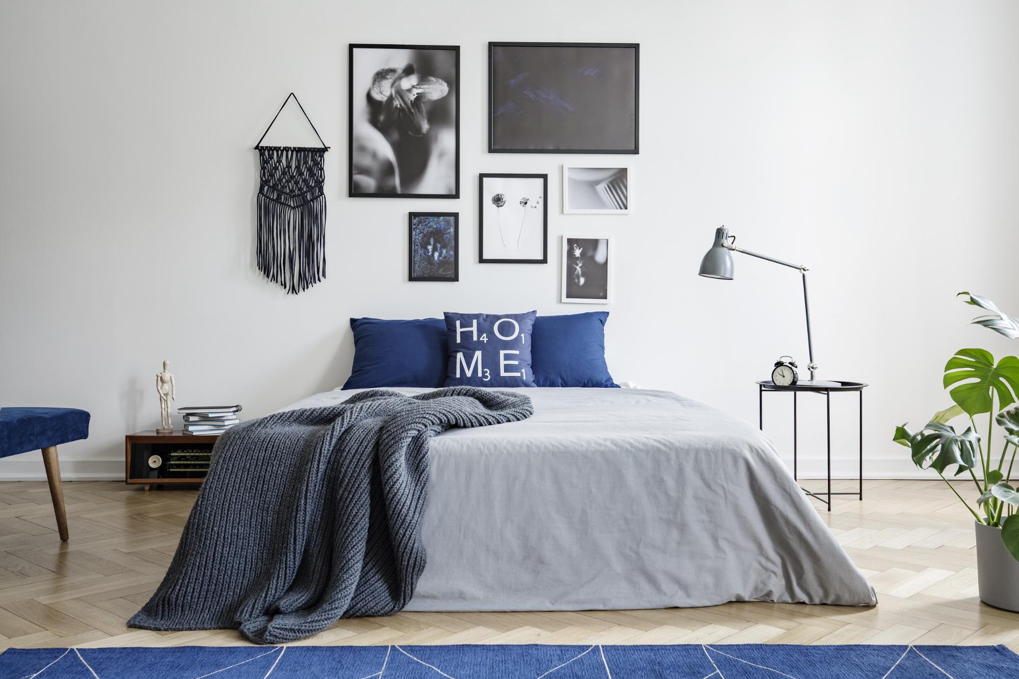 end table with storage: Bedroom with a blue and grey color theme