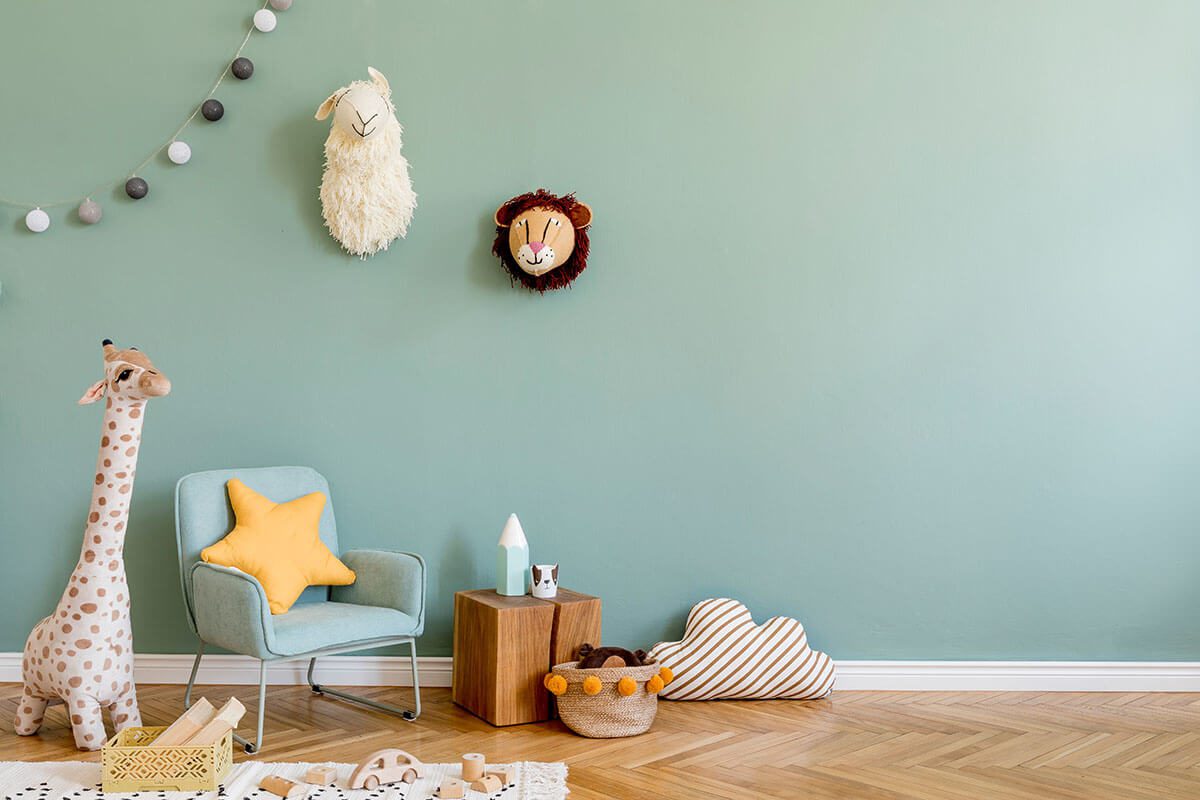 Light blue armchair with a star shaped pillow, stuffed animals and wooden toys