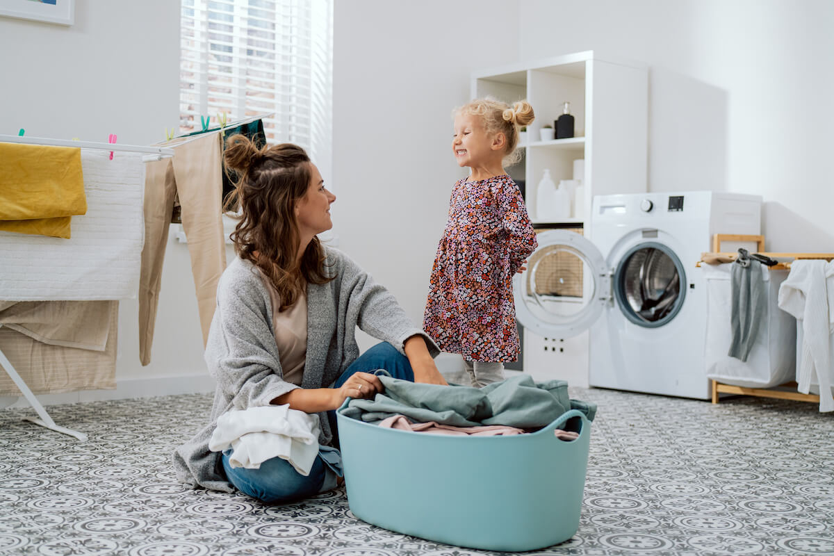 Mother looking at her child while sorting their clothes