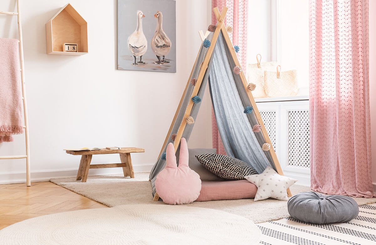 reading nook: Pink and white children's room with a tent and a wooden bench