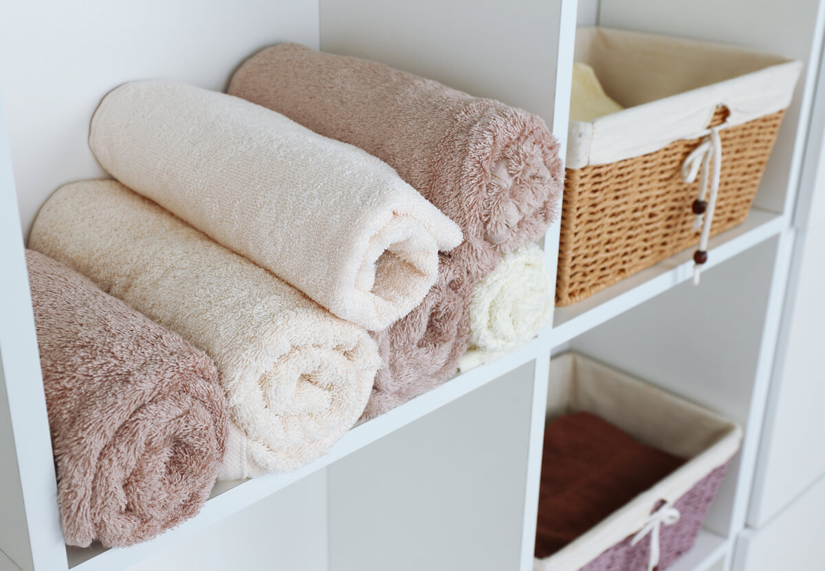 Rolled towels in a bathroom shelf