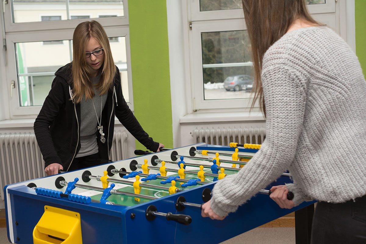 two girls playing foosball